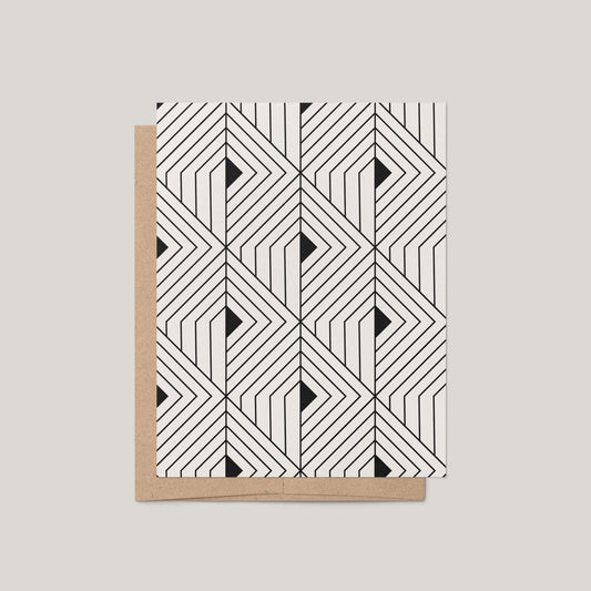 The Prism Greeting Card by Blú Rose featuring a bold black and off-white geometric angular pattern shown with a kraft envelope on a gray background