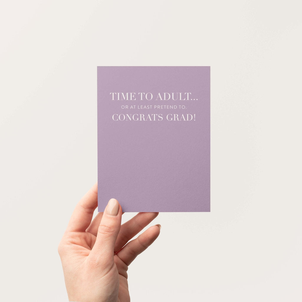 Time to Adult graduation greeting card by Blú Rose held in hand against a neutral off-white background