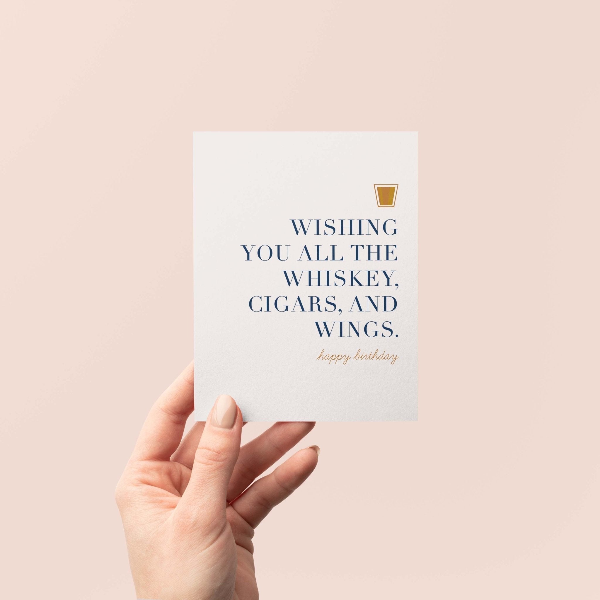 Whiskey Birthday greeting card by Blú Rose held in hand against a neutral off-white background