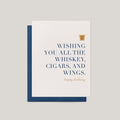 Whiskey Birthday greeting card by Blú Rose, ivory card with navy serif whiskey cigars and wings text, shown with blue envelope