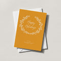 White Wreath card in marigold with a white botanical wreath around Happy Holidays script