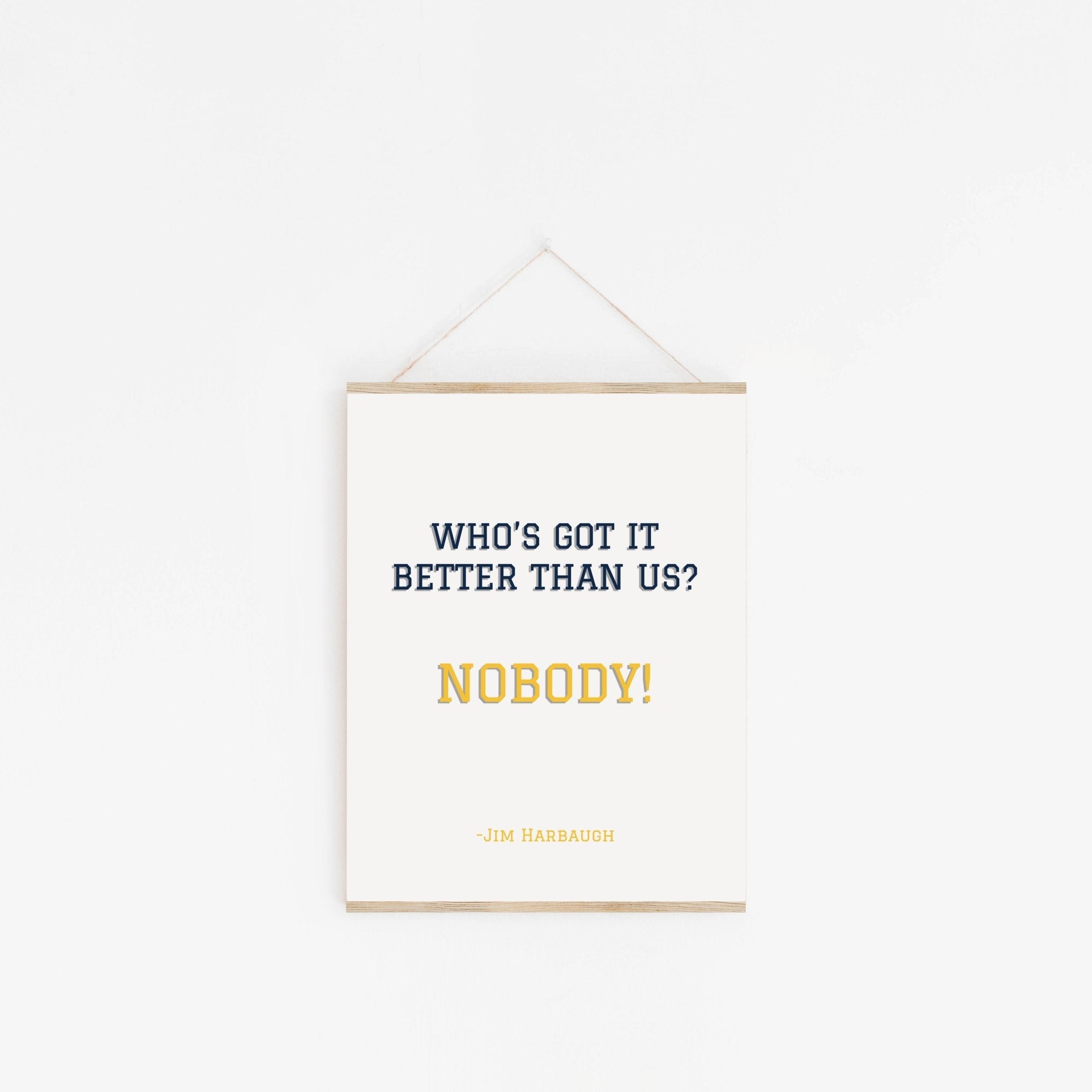 Inspirational sports typography poster hanging from wooden hanger