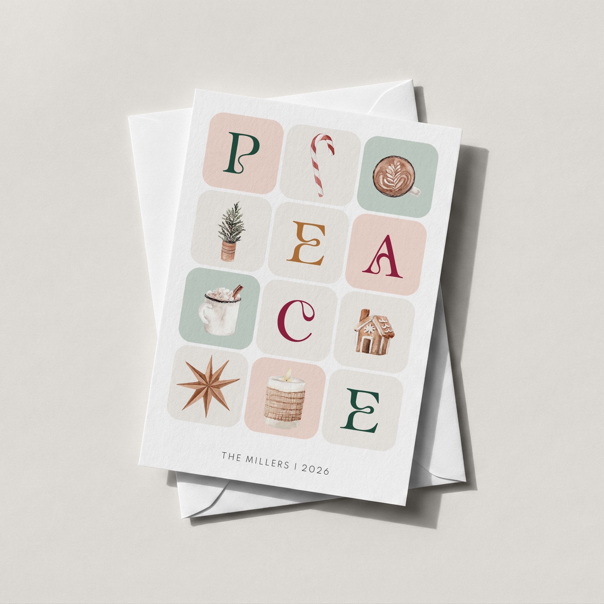 Winter Blocks card with its forest green patterned envelope liner styled on a blush backdrop