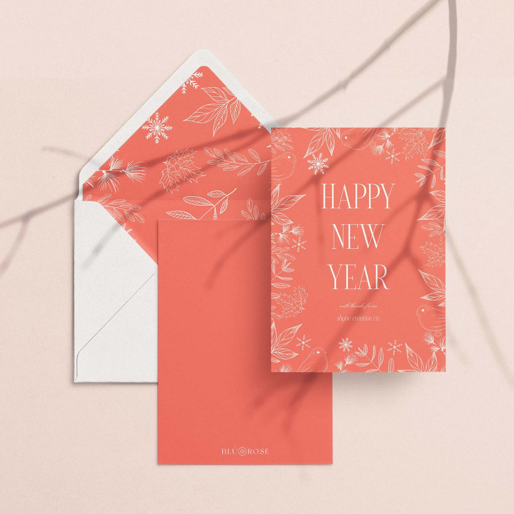 Winter Forest card with its coral snowflake envelope liner styled on a blush backdrop