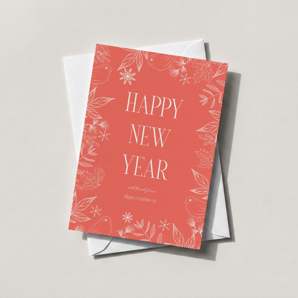 Winter Forest holiday card in warm coral with HAPPY NEW YEAR and a scattered snowflake print