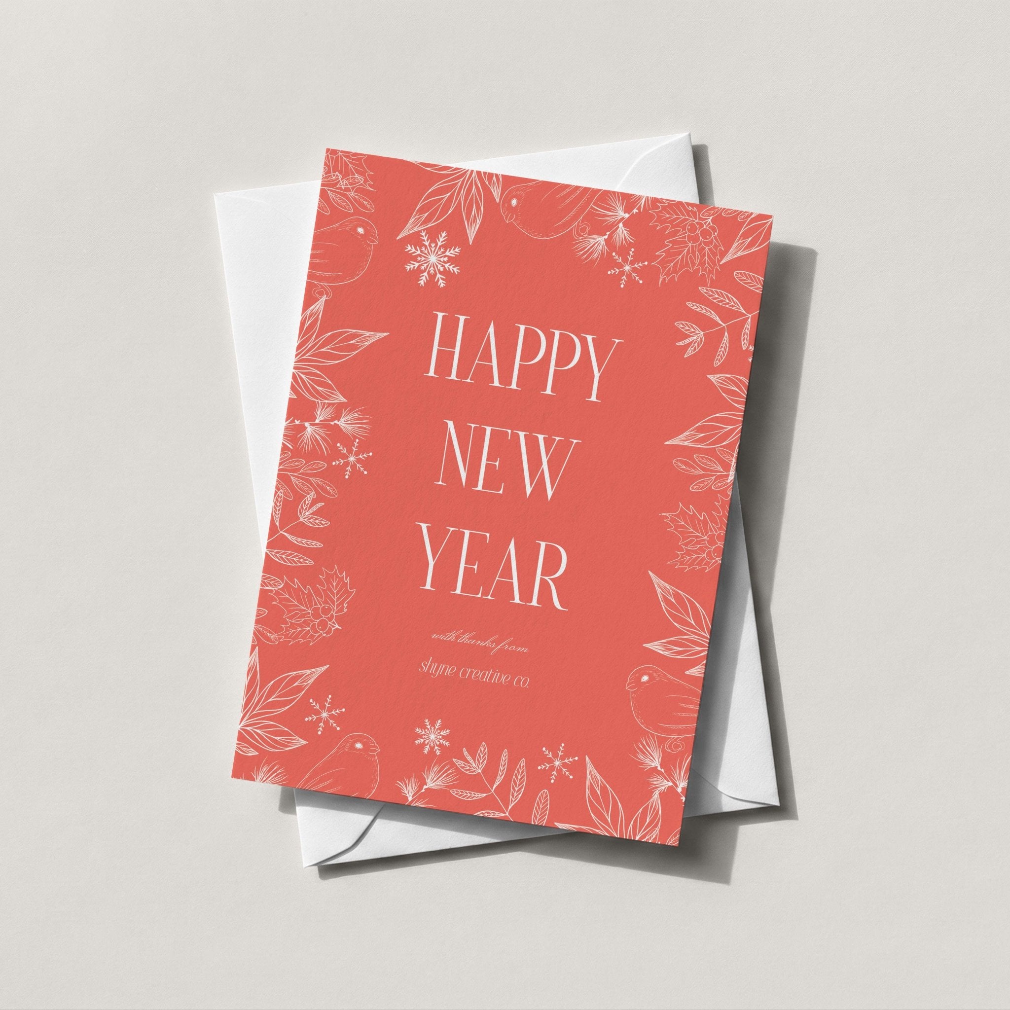 Winter Forest holiday card in warm coral with HAPPY NEW YEAR and a scattered snowflake print