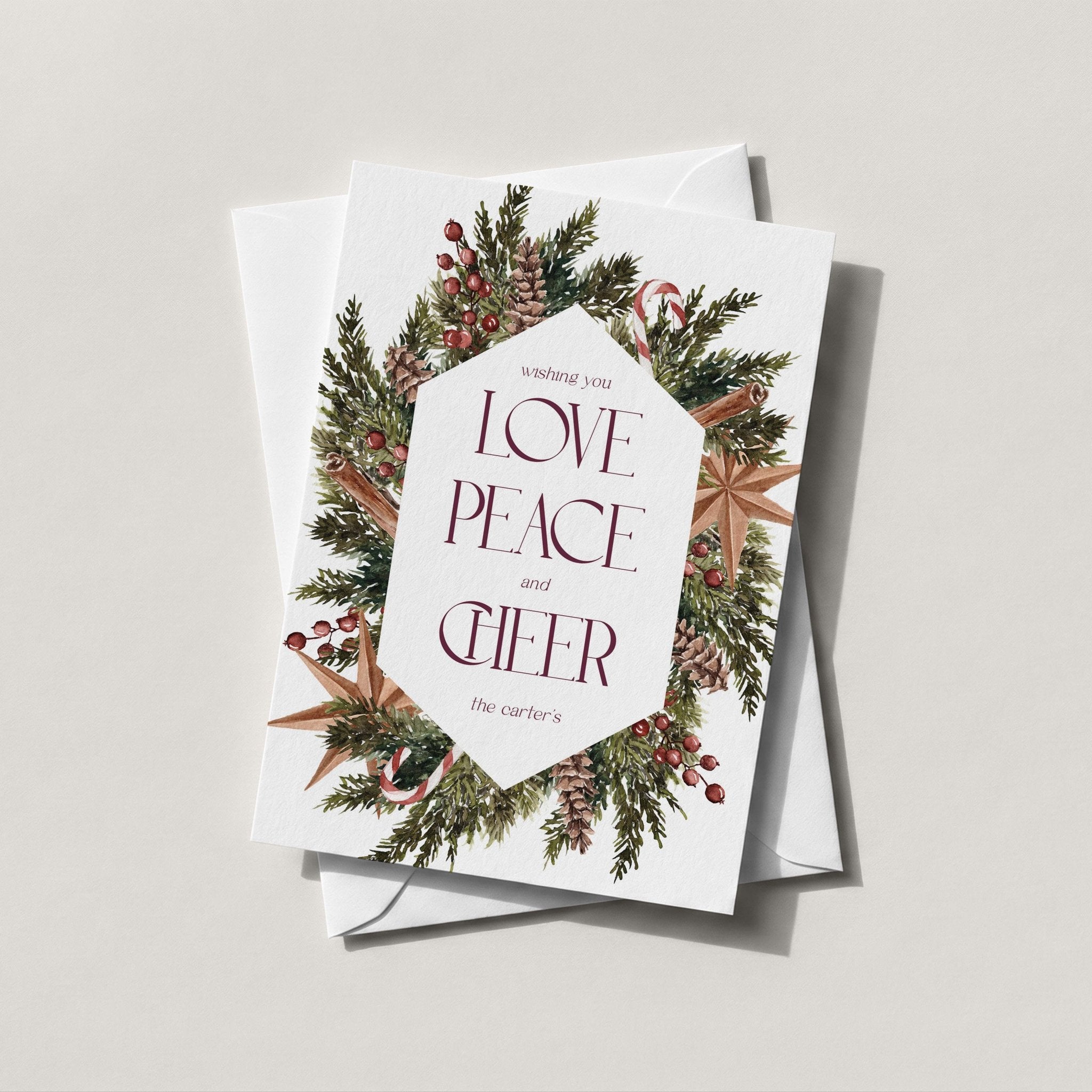 Winter Wreath holiday card with a pine and berry wreath framing LOVE PEACE CHEER in a diamond