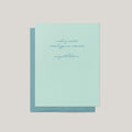A mint green congratulations card with elegant cursive text, shown with a matching teal envelope against a neutral light gray background.