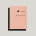 You Did It graduation money greeting card by Blú Rose, peach card with graduation cap and there's money in here text, shown with black envelope