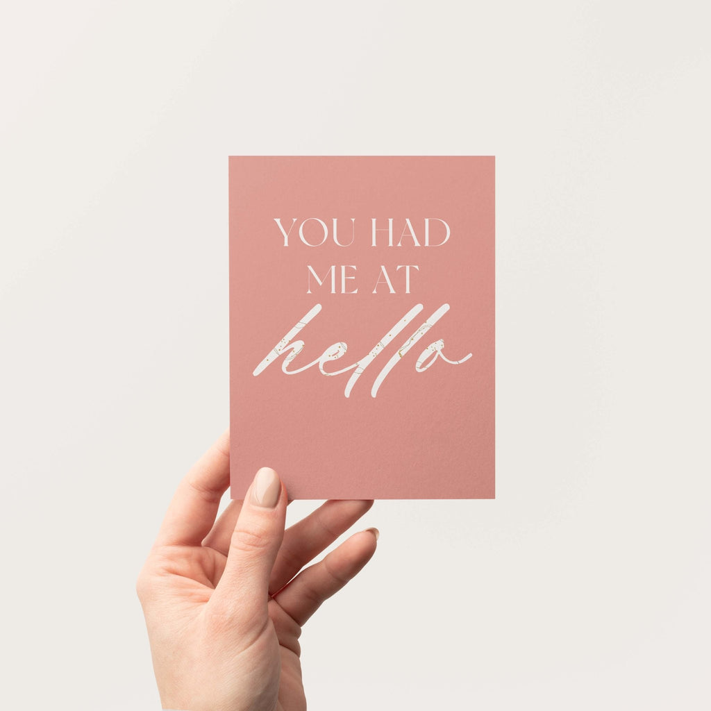 You Had Me at Hello greeting card by Blú Rose held in hand against a neutral off-white background