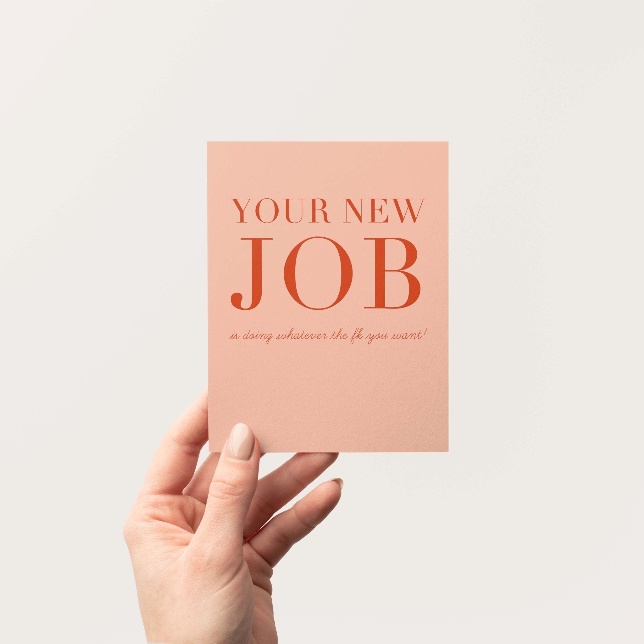 Your New Job Is retirement greeting card by Blú Rose held in hand against a neutral off-white background