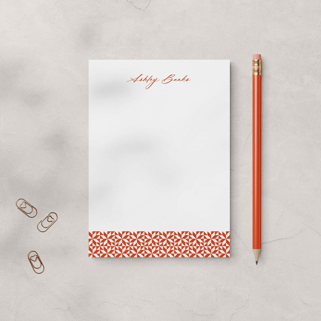 Ashley stationery set by Blú Rose, rust geometric-accent notepad personalized 'Ashley Banks', styled with a rust pencil and heart paper clips