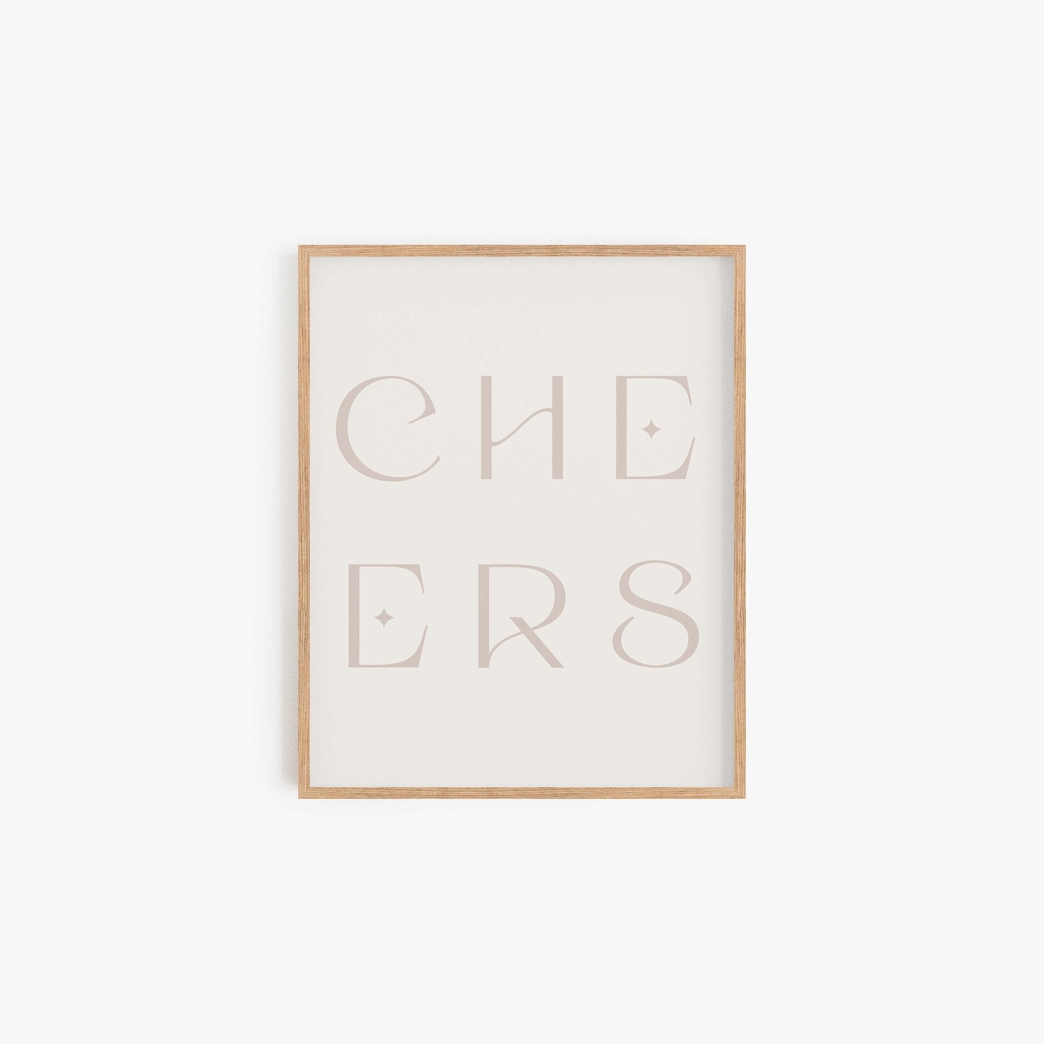 Minimal “CHEERS” typography art print in a neutral beige frame displayed on a white wall.