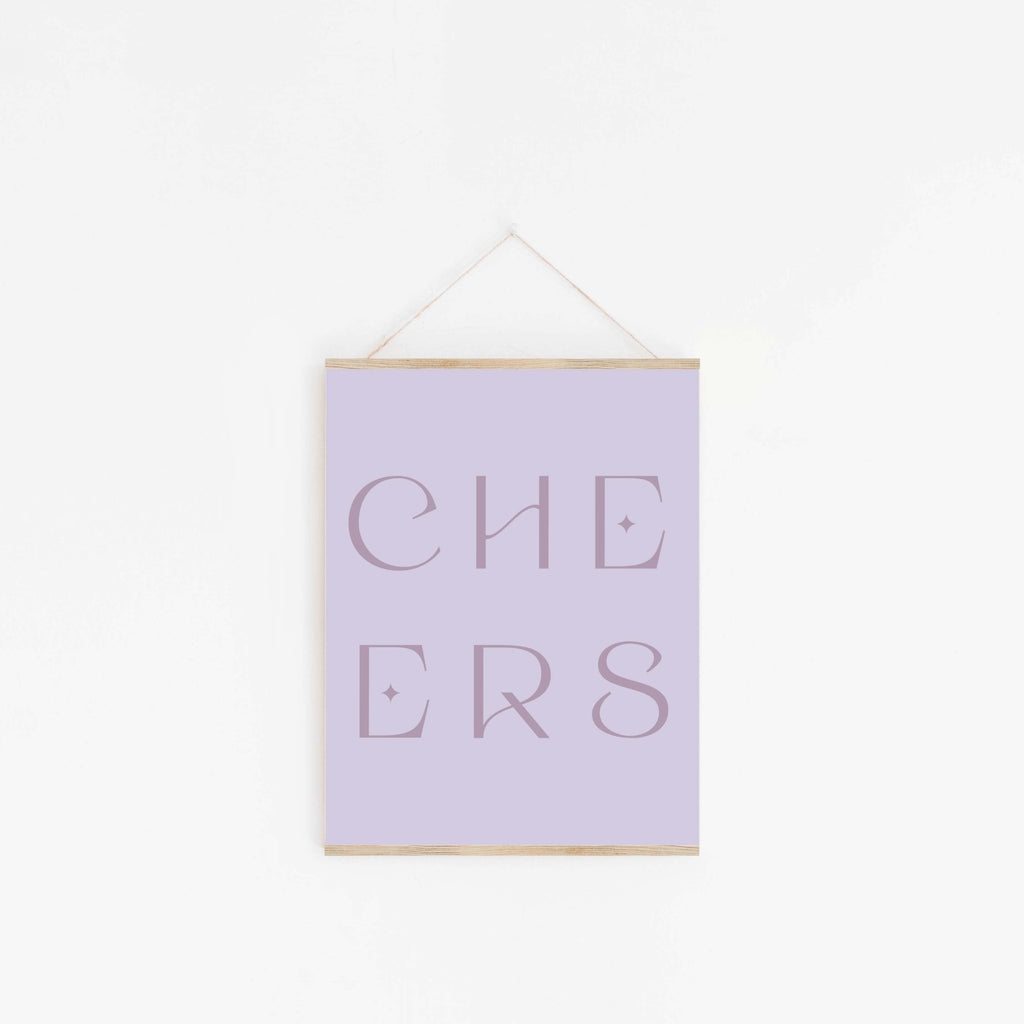 Pastel lavender “CHEERS” typography art print hanging on white wall.