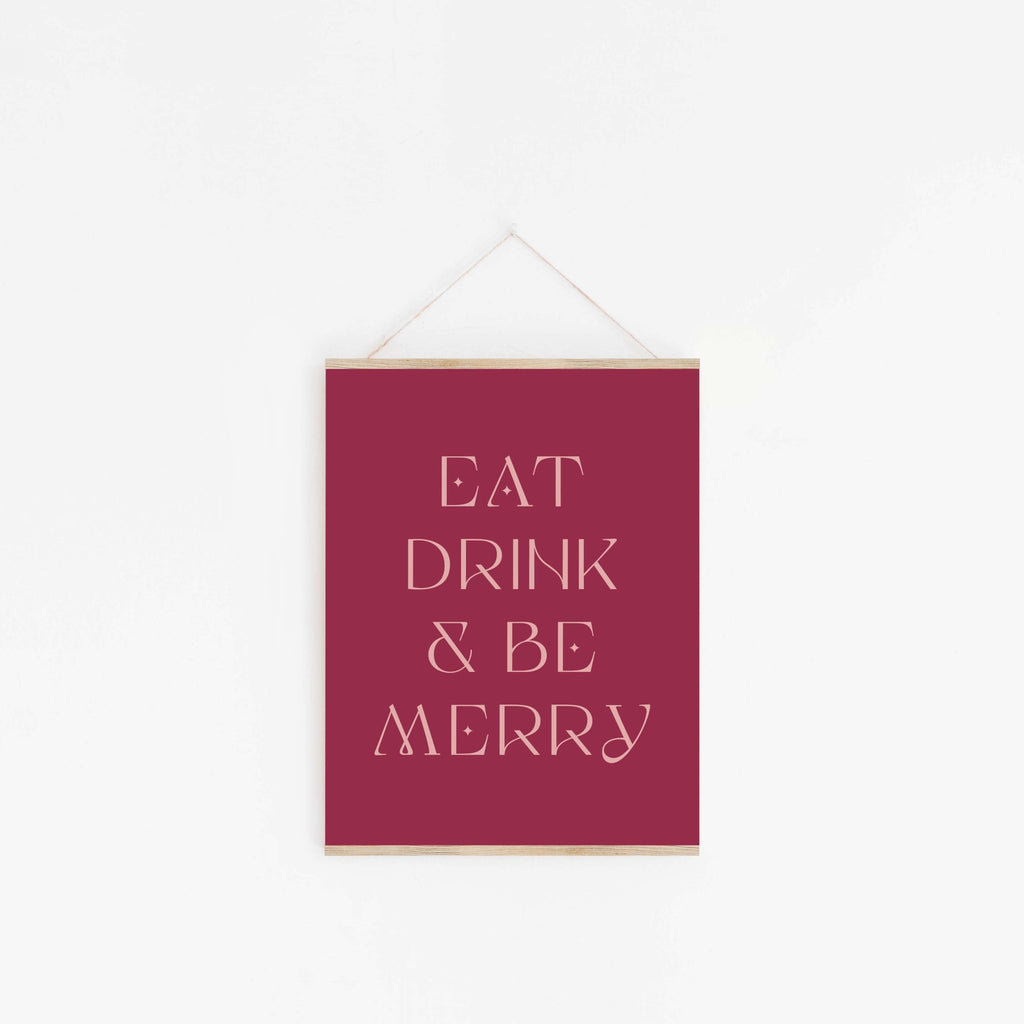 Festive Eat Drink & Be Merry typography art print hanging on the wall with minimalist styling