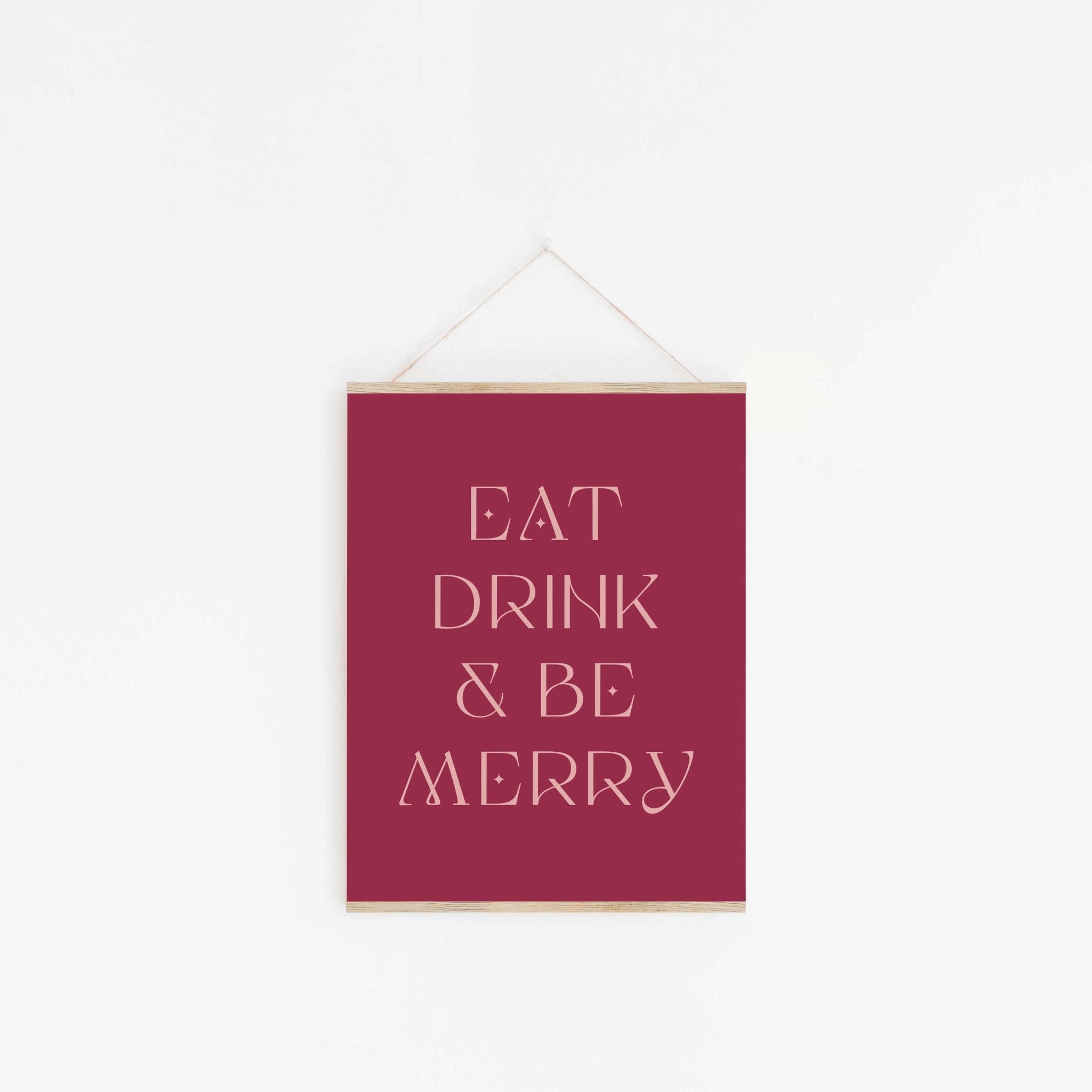 Festive Eat Drink & Be Merry typography art print hanging on the wall with minimalist styling