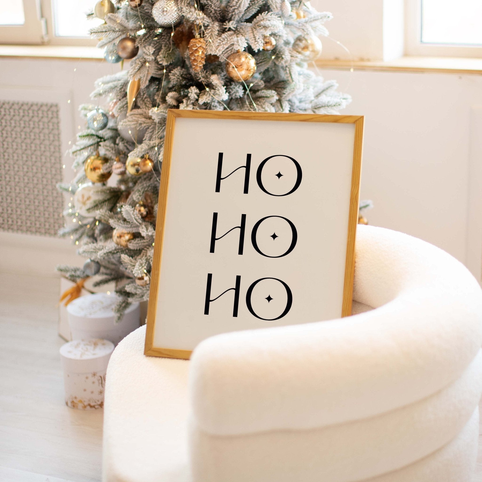 Ho Ho Ho holiday typography print displayed beside decorated Christmas tree