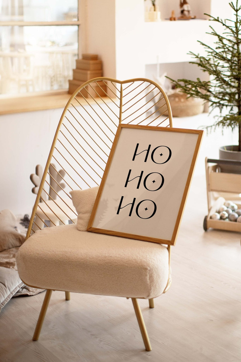 Ho Ho Ho Christmas poster leaning on chair in cozy living room