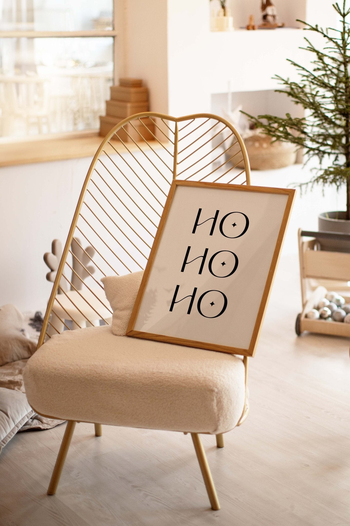 Ho Ho Ho Christmas poster leaning on chair in cozy living room
