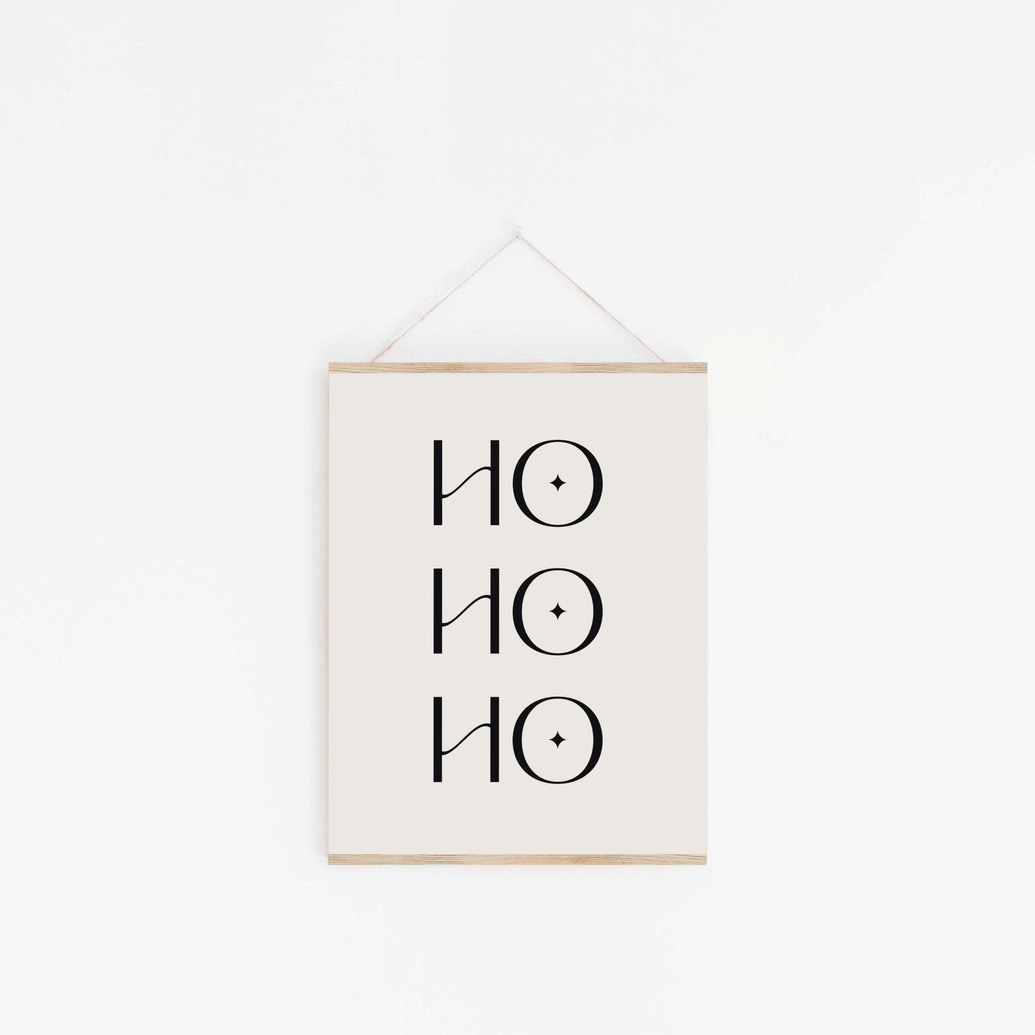 Minimalist Ho Ho Ho Christmas poster hanging from wooden hanger
