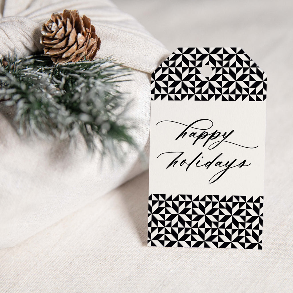 Holiday Pattern gift tags by Blú Rose, 'happy holidays' black and white geometric tag styled on white linen with a pinecone and pine sprig