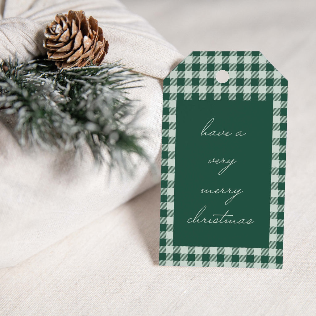 Holiday Plaid gift tags by Blú Rose, green gingham 'have a very merry christmas' tag styled on white linen with a pinecone and pine sprig