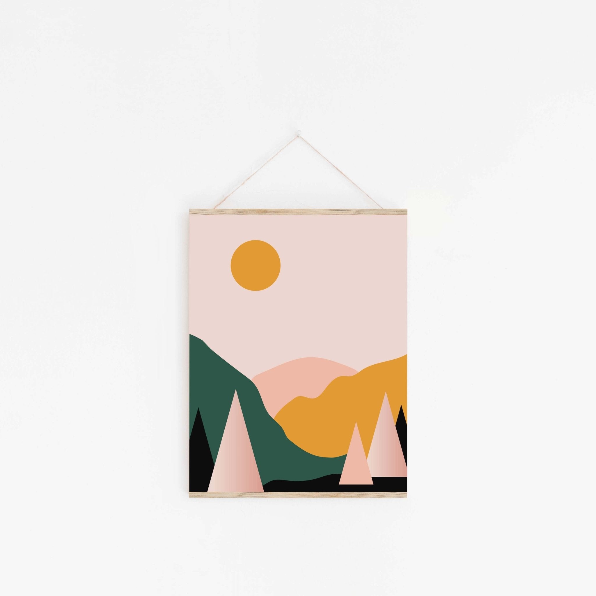 Minimalist mountain art poster hanging from wooden hanger on off-white background