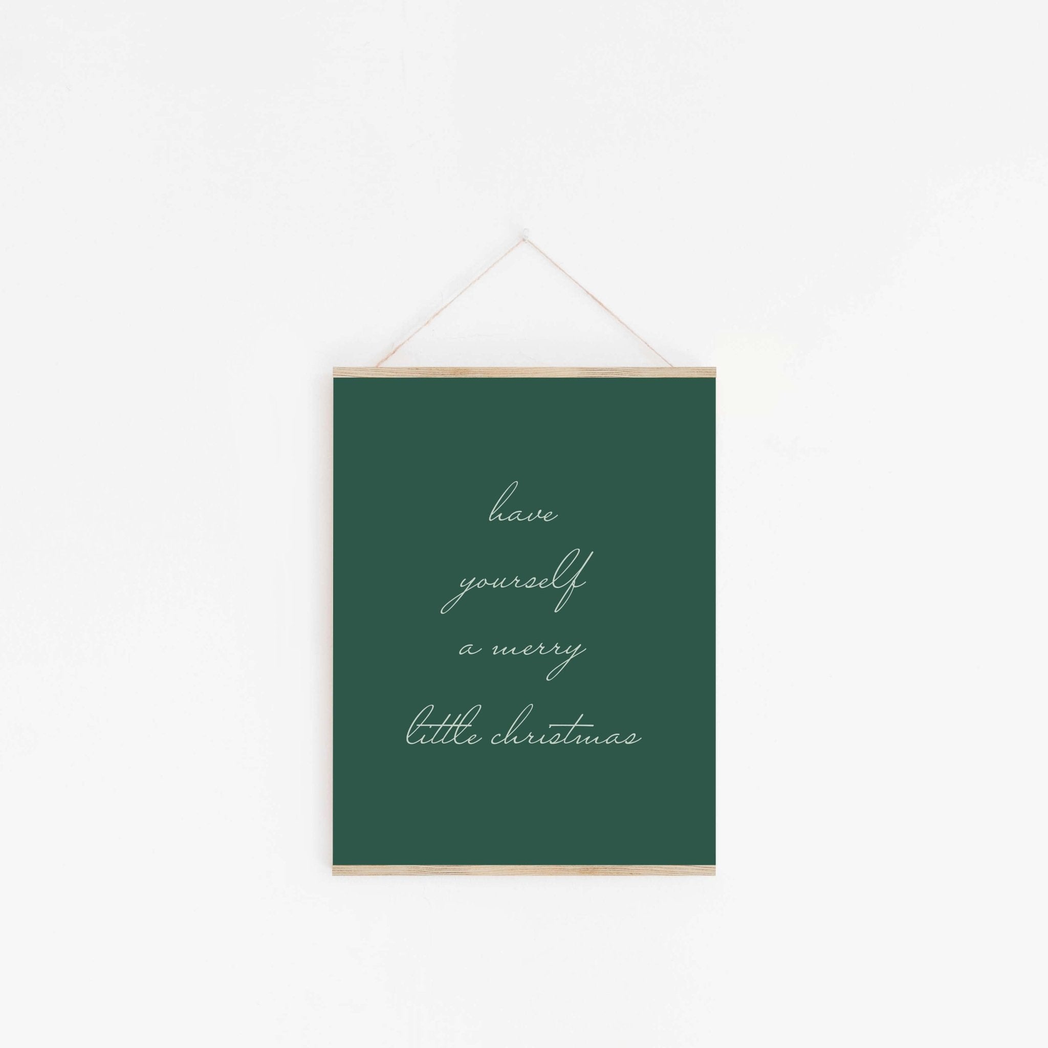 Green Christmas typography wall art hanging from wooden hanger