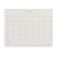Minimalist Monthly Planner notepad by Blú Rose, undated monthly calendar grid with 'This Month', weekday columns, goals and notes sections in navy