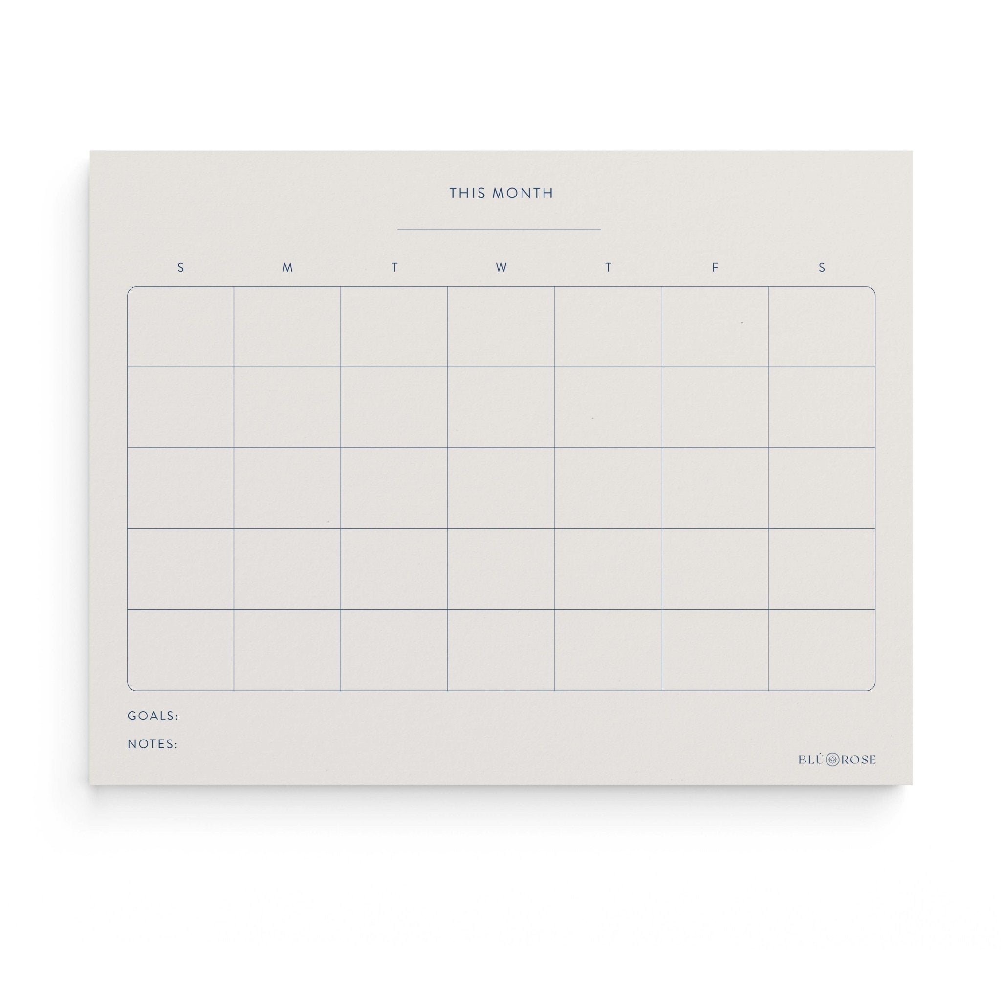 Minimalist Monthly Planner notepad by Blú Rose, undated monthly calendar grid with 'This Month', weekday columns, goals and notes sections in navy
