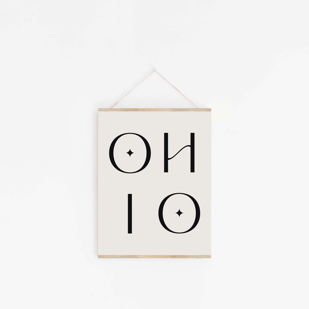 Ohio typography poster hanging from wooden hanger on off-white background