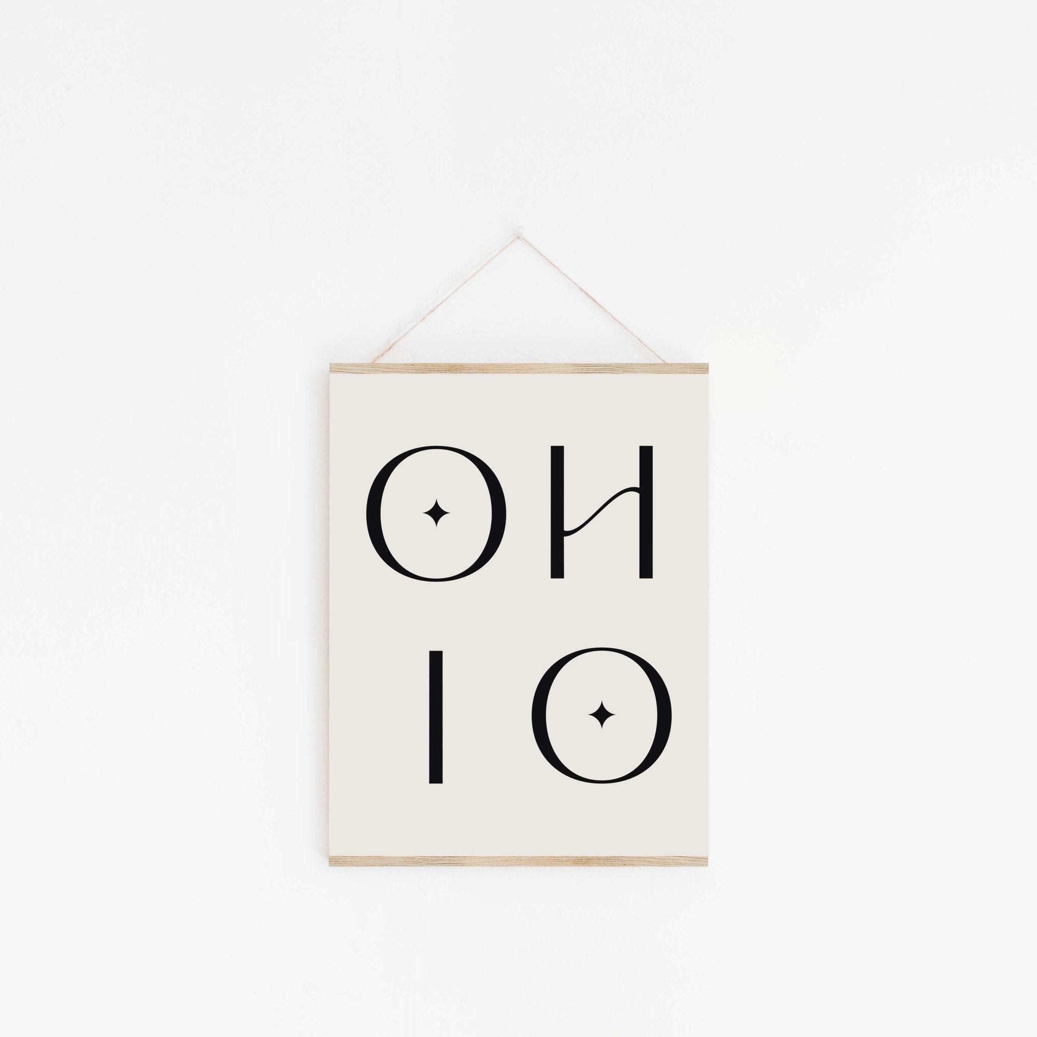 Ohio typography poster hanging from wooden hanger on off-white background