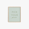 Pick Your Poison typography art print in sage green with minimalist lettering in light wood frame