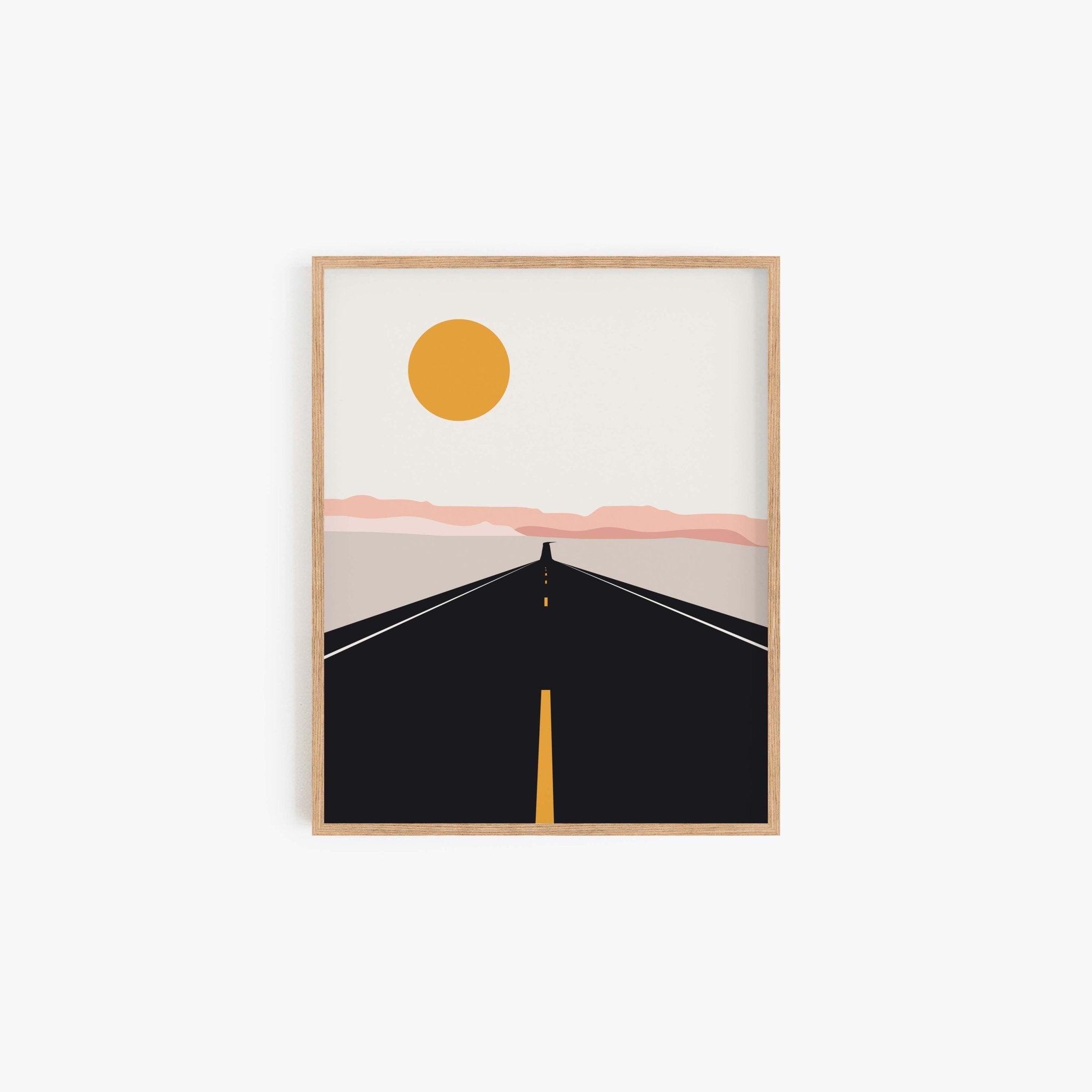 Minimalist road trip art print with sun over black road in a light wood frame.